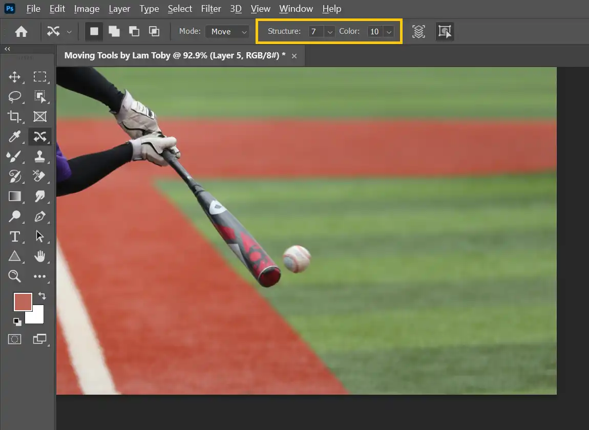 Photoshop tutorial of how to move objects with a sample photo of a baseball bat hitting the ball. The screenshot here highlights how to adjust the structure and color using the content-aware move tool.